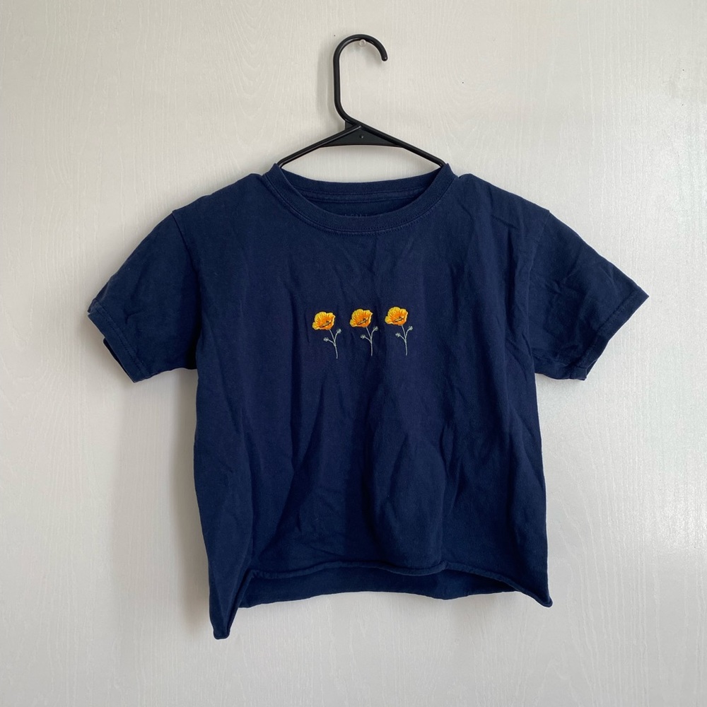 Blue raw cut tee with poppies. John Galt